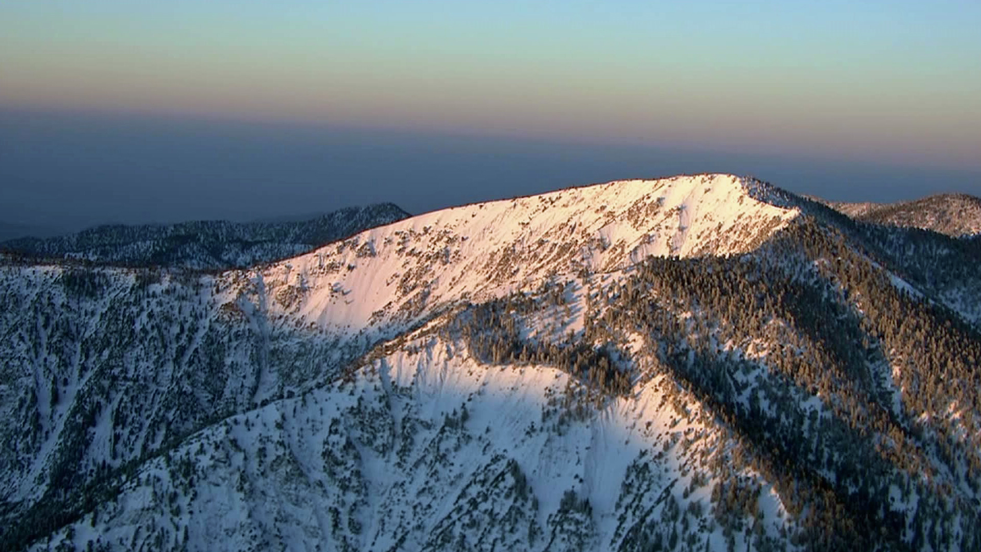 A file photo shows snow in the mountains of Southern California.