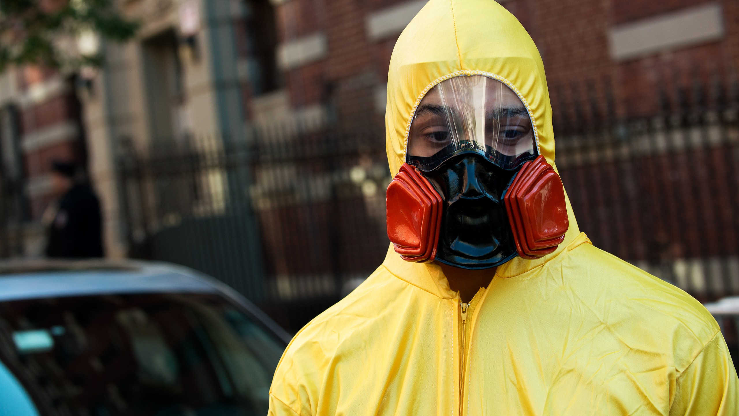 A young man, dressed in a biohazard costume, stands on the corner of 546 West 147th Street on Saturday, Oct. 25, 2014, in New York City. (Credit: Bryan Thomas/Getty Images)