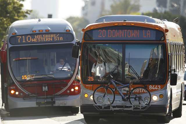 File photo of two Metro buses at Wilshire Boulevard and Western Avenue. (Credit: Robert Gauthier / Los Angeles Times)