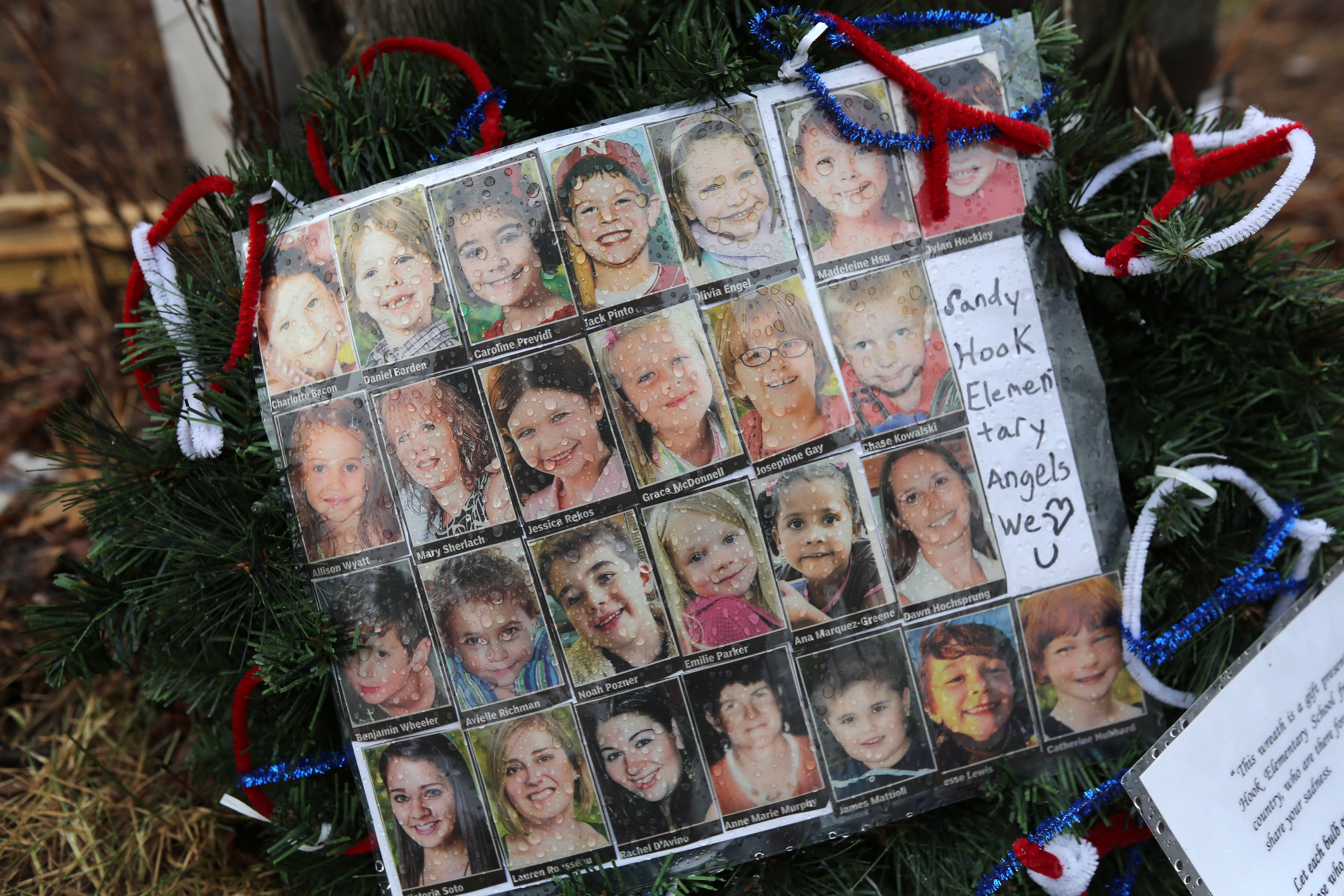 Photos of Sandy Hook Elementary School massacre victims sits at a small memorial near the school on Monday, Jan. 14, 2013, in Newtown, Connecticut. (Credit: John Moore/Getty Images)