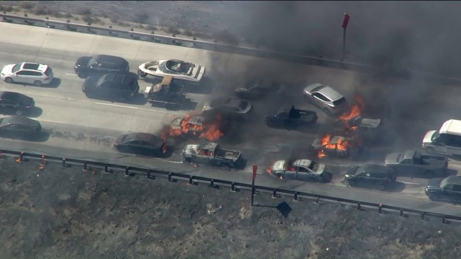 A rapid-moving wildfire on Friday, July 17, 2015, in the Cajon Pass spread from vegetation to vehicles stopped on the 15 Freeway. (Credit: KTLA)