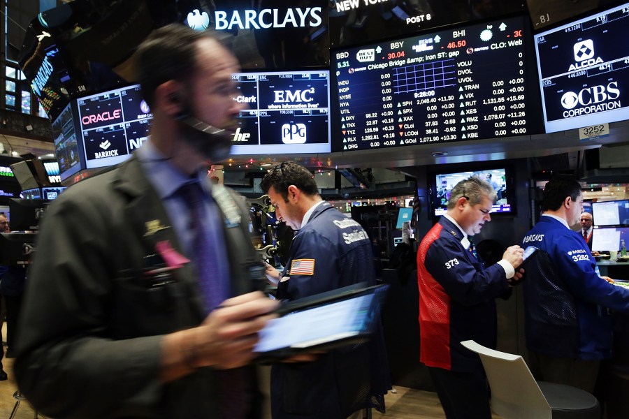 Traders work on the floor of the New York Stock Exchange on Dec. 16, 2015, in New York City. Stocks were up in morning trading just hours before it is expected that the Federal Reserve announced it would raise interest rates for the first time in nearly a decade. (Credit: Spencer Platt/Getty Images)