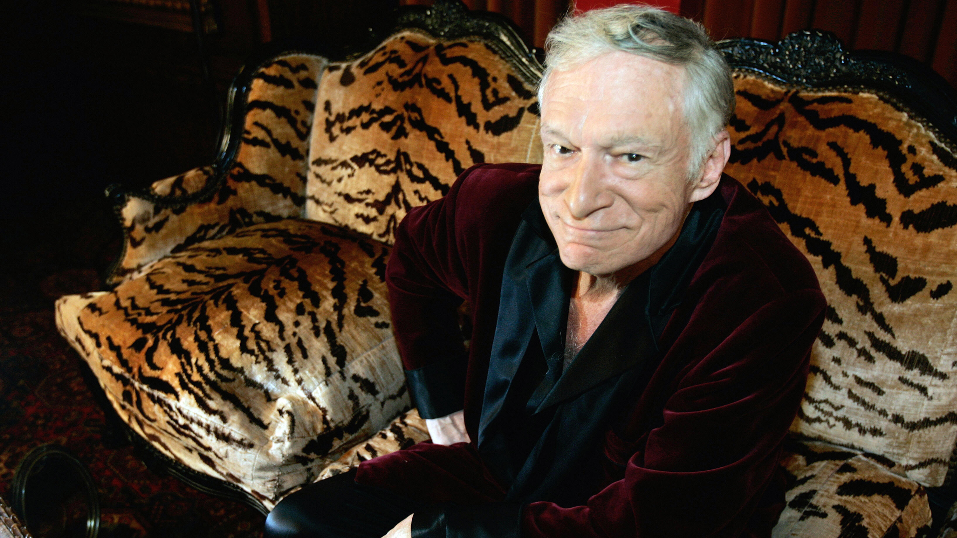 Hugh Hefner, CEO of Playboy Enterprises, poses for a photo during an interview with journalists at his mansion in Los Angeles, in 2006. (Credit: Hector Mata/AFP/Getty Images)