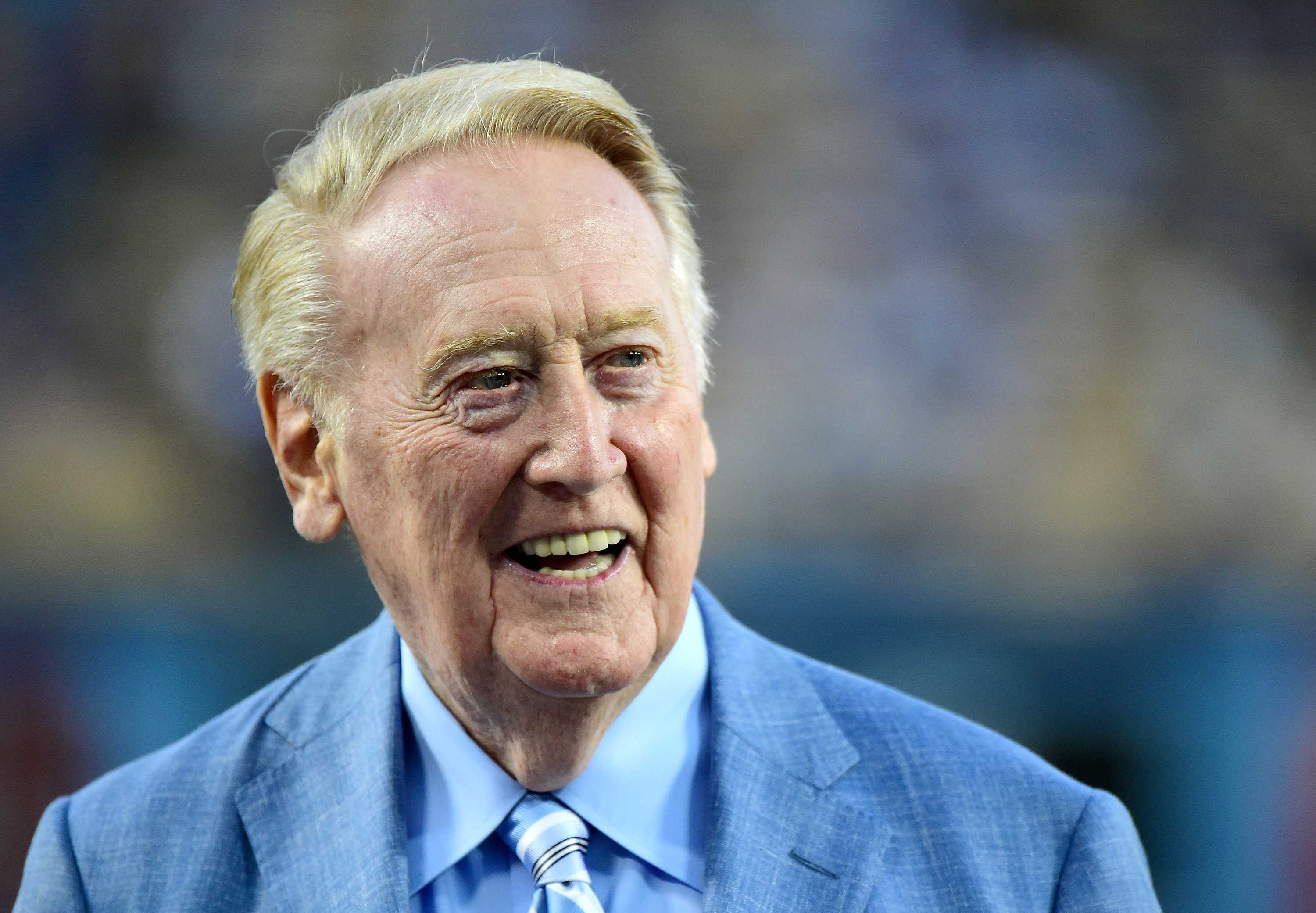 Los Angeles Dodgers broadcaster Vin Scully smiles on the field before the game against the Arizona Diamondbacks at Dodger Stadium on Sept. 23, 2015. (Harry How/Getty Images)