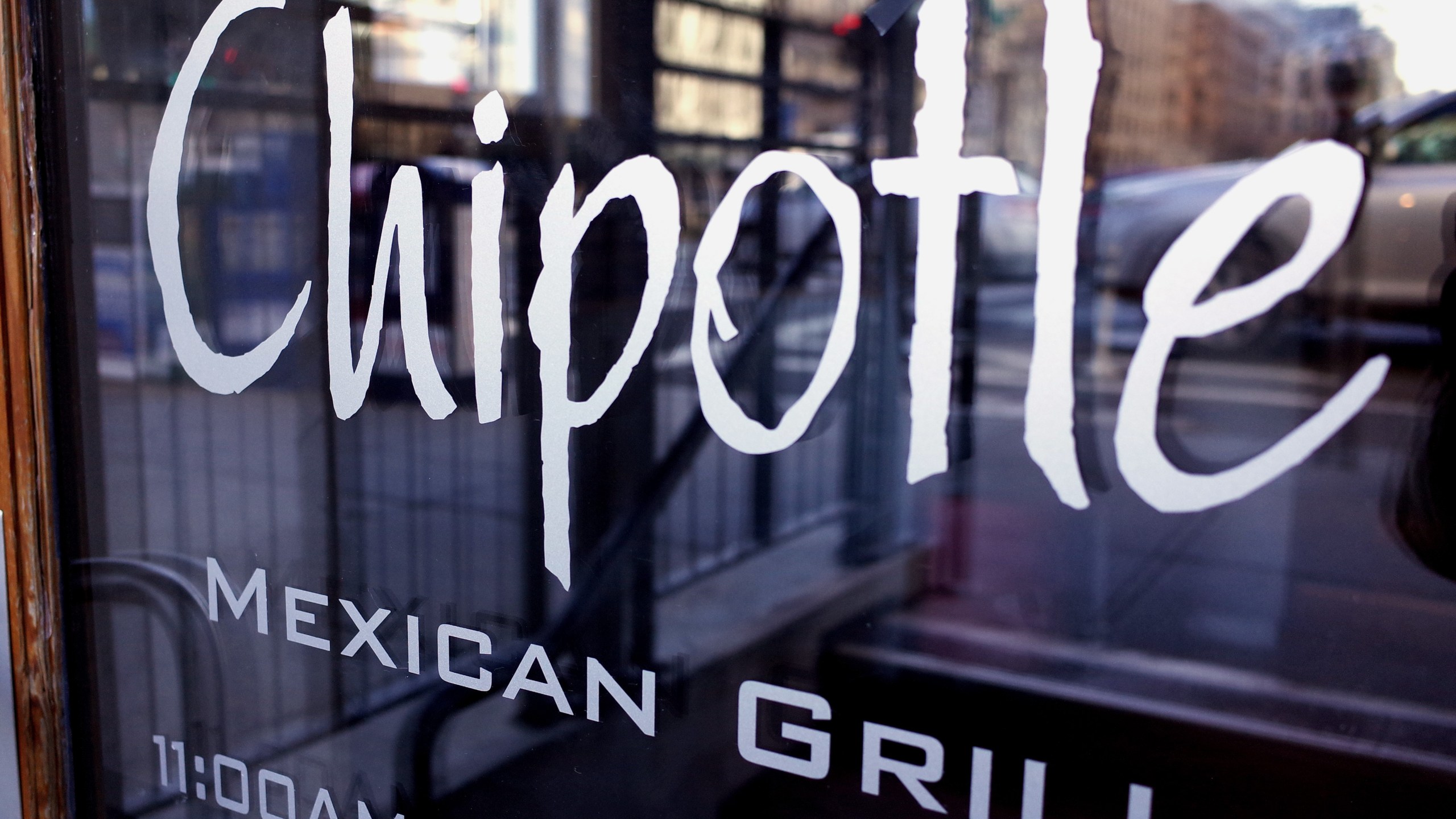 The Chipotle logo is seen on the door of one of its restaurants on Jan. 11, 2015, in Washington, D.C. (Credit: MANDEL NGAN/AFP/Getty Images)