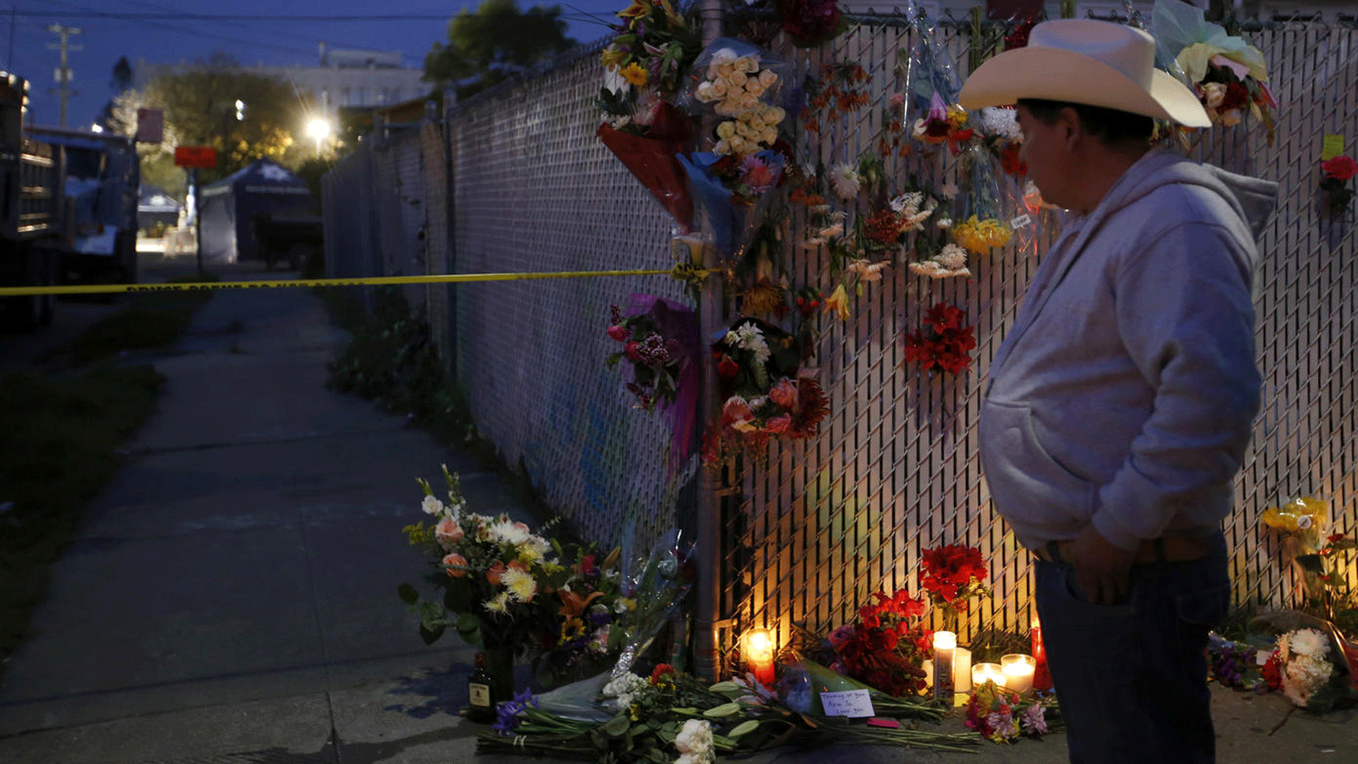 A makeshift memorial of flowers and candles stands Dec. 4, 2017, near the site of the Oakland warehouse fire. (Credit: Francine Orr / Los Angeles Times)