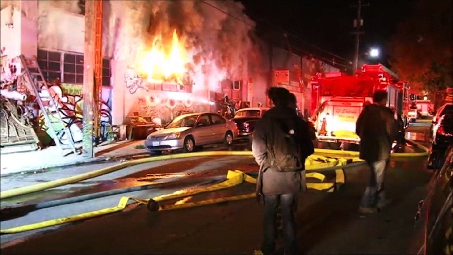 Firefights battle a fire at a warehouse in Oakland, CA. (Credit: CNN)