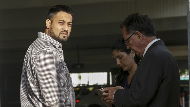 Syed Raheel Farook, left, is released on bail at the Riverside Federal Courthouse in April 2016. (Credit: Irfan Khan / Los Angeles Times)