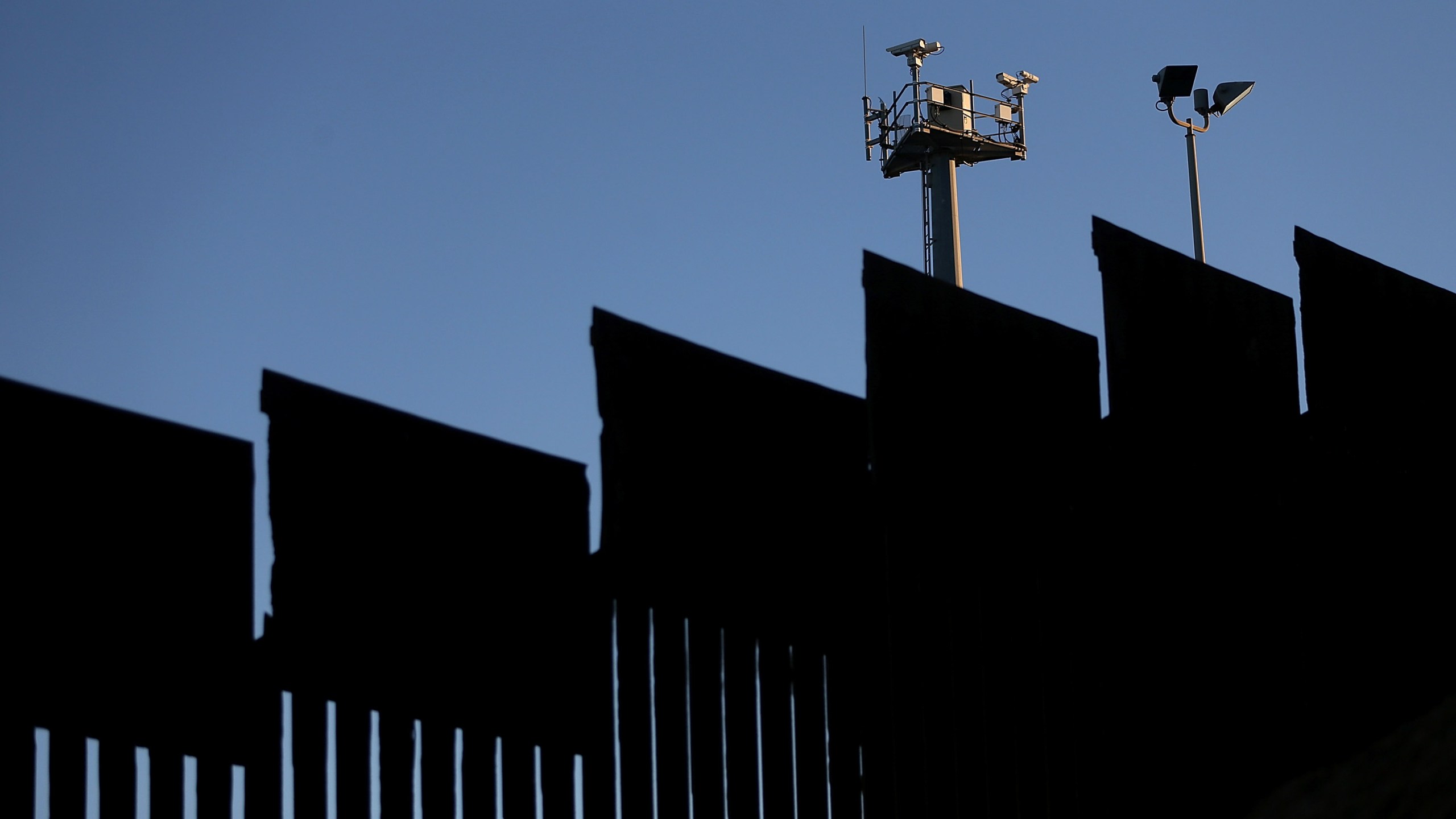 Surveillance cameras stand above the U.S.-Mexican border fence at Playas de Tijuana on Jan. 27, 2017, in Tijuana, Mexico. (Credit: Justin Sullivan/Getty Images)