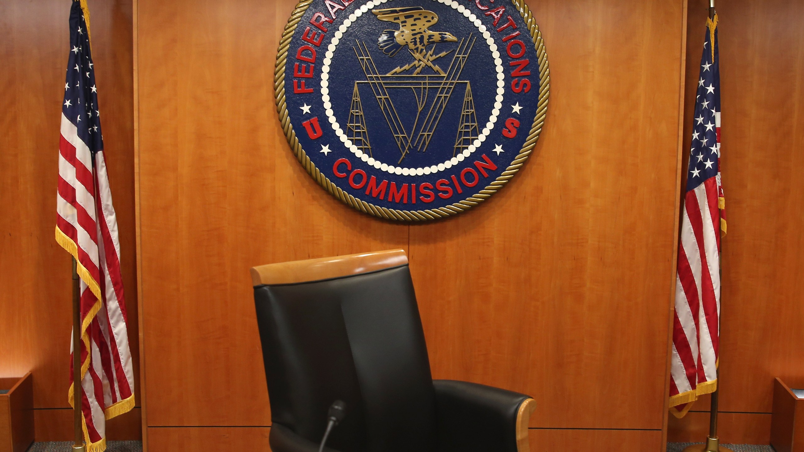 The seal of the Federal Communications Commission hangs behind the commissioner's chair inside the hearing room at the FCC headquarters Feb. 26, 2015, in Washington, D.C. (Credit: Mark Wilson/Getty Images)