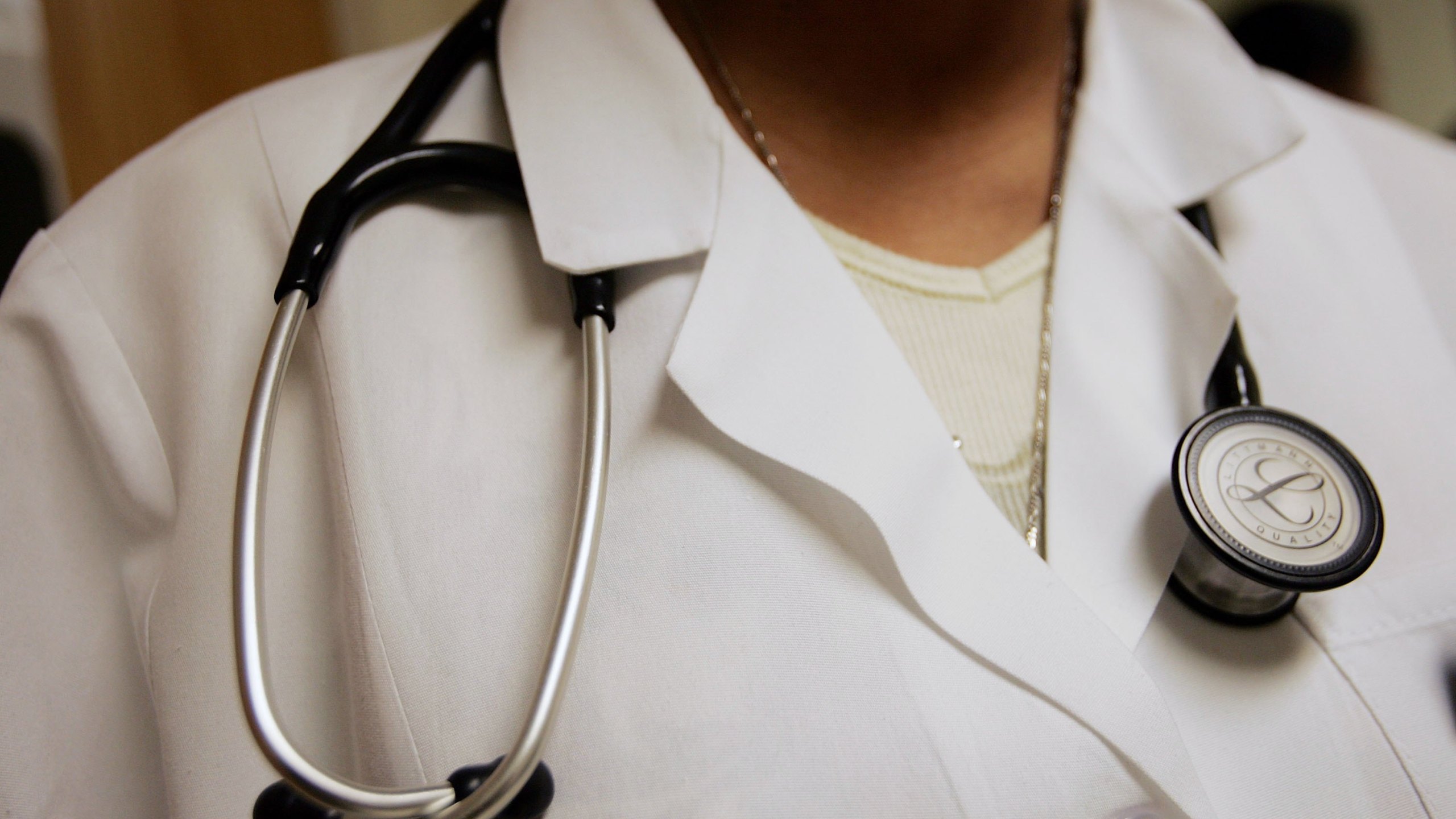 Dominique Entzminger, a physician assistant of family medicine, wears a stethoscope during an examination at the Codman Square Health Center April 5, 2006, in Dorchester, Massachusetts. (Credit: Joe Raedle/Getty Images)