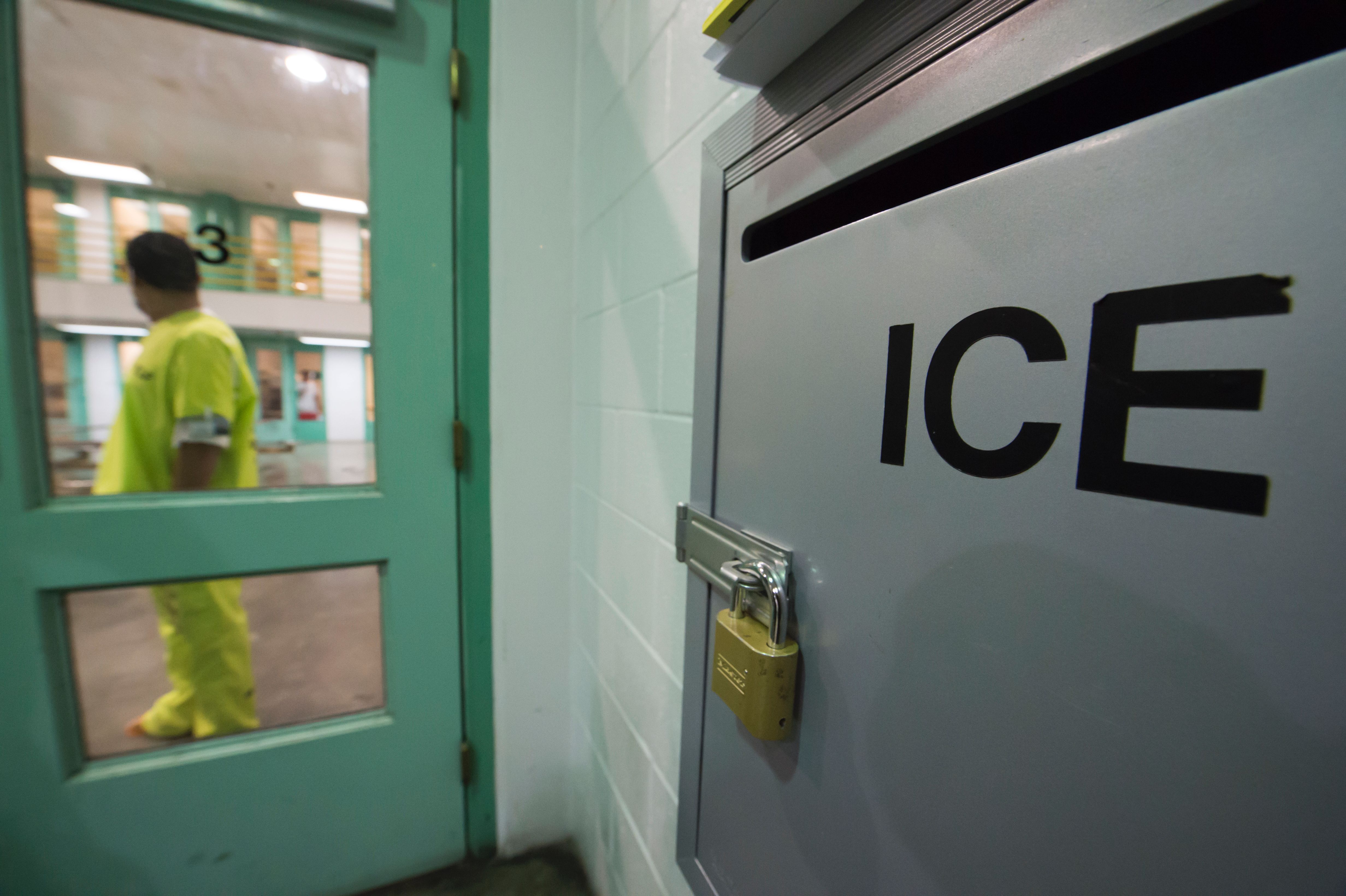 An immigration detainee stands near a U.S. Immigration and Customs Enforcement grievance box in the high-security unit at the Theo Lacy Facility, a county jail in Orange that also houses immigration detainees arrested by ICE, on March 14, 2017. (Credit: Robyn Beck / AFP / Getty Images)