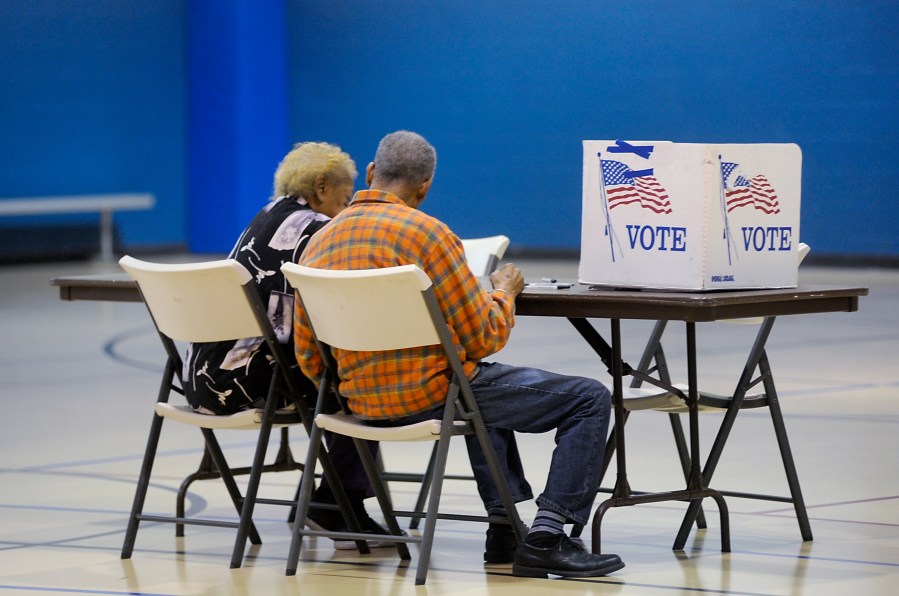 A couple reads a ballot prior to voting on Nov. 8, 2016, in Durham, North Carolina. (Credit: Sara D. Davis/Getty Images)