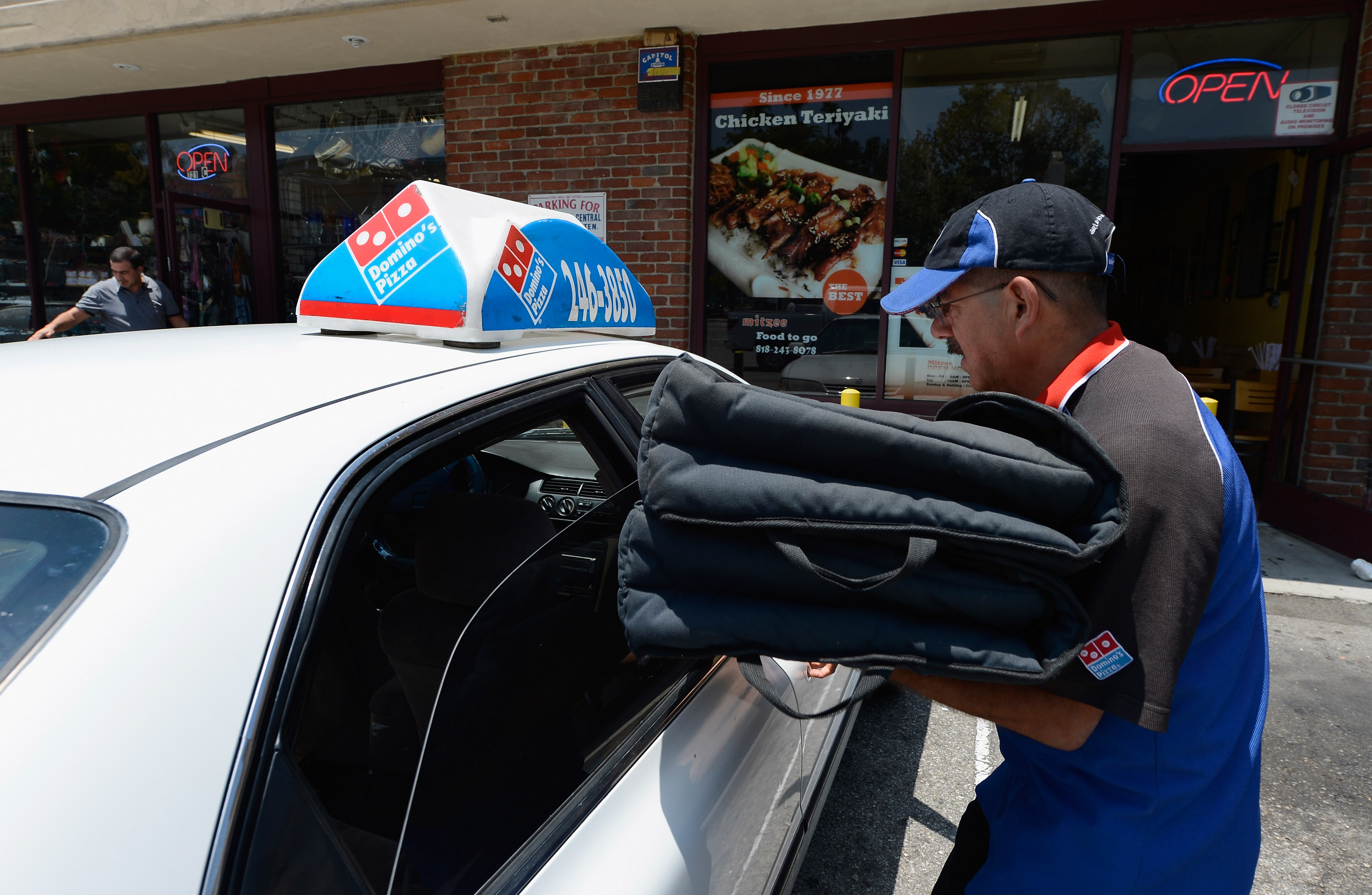 A Domino's Pizza delivery man sets out for delivery on June 21, 2012, in Glendale, California. (Kevork Djansezian/Getty Images)