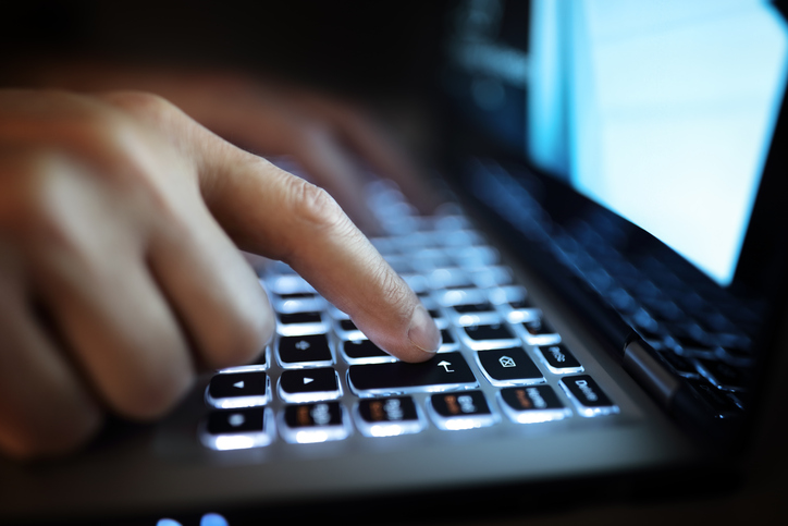 A person is seen typing on a computer. (Credit: Getty Images)