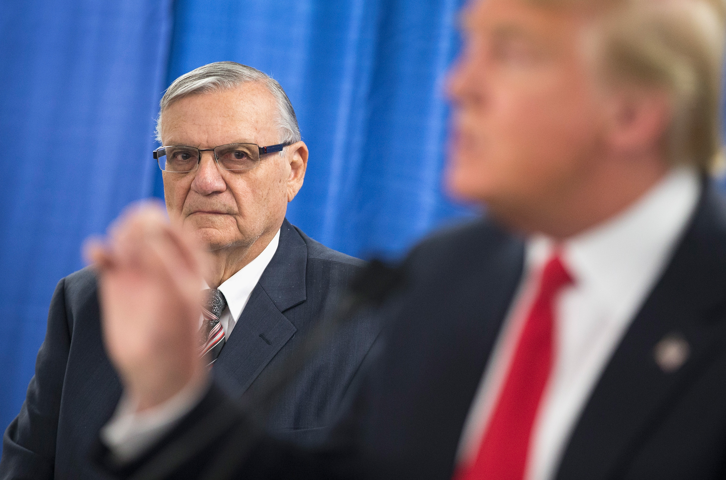 Sheriff Joe Arpaio of Maricopa County, Arizona, listens as Republican presidential candidate Donald Trump speaks to the press prior to a rally on Jan. 26, 2016, in Marshalltown, Iowa. (Credit: Scott Olson/Getty Images)