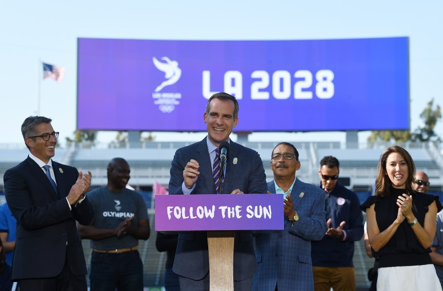 Los Angeles Mayor Eric Garcetti speaks at the podium as he announces a deal has been reached with the International Olympic Committee to host the 2028 Summer Olympics. (Credit: Kevork Djansezian/Getty Images)