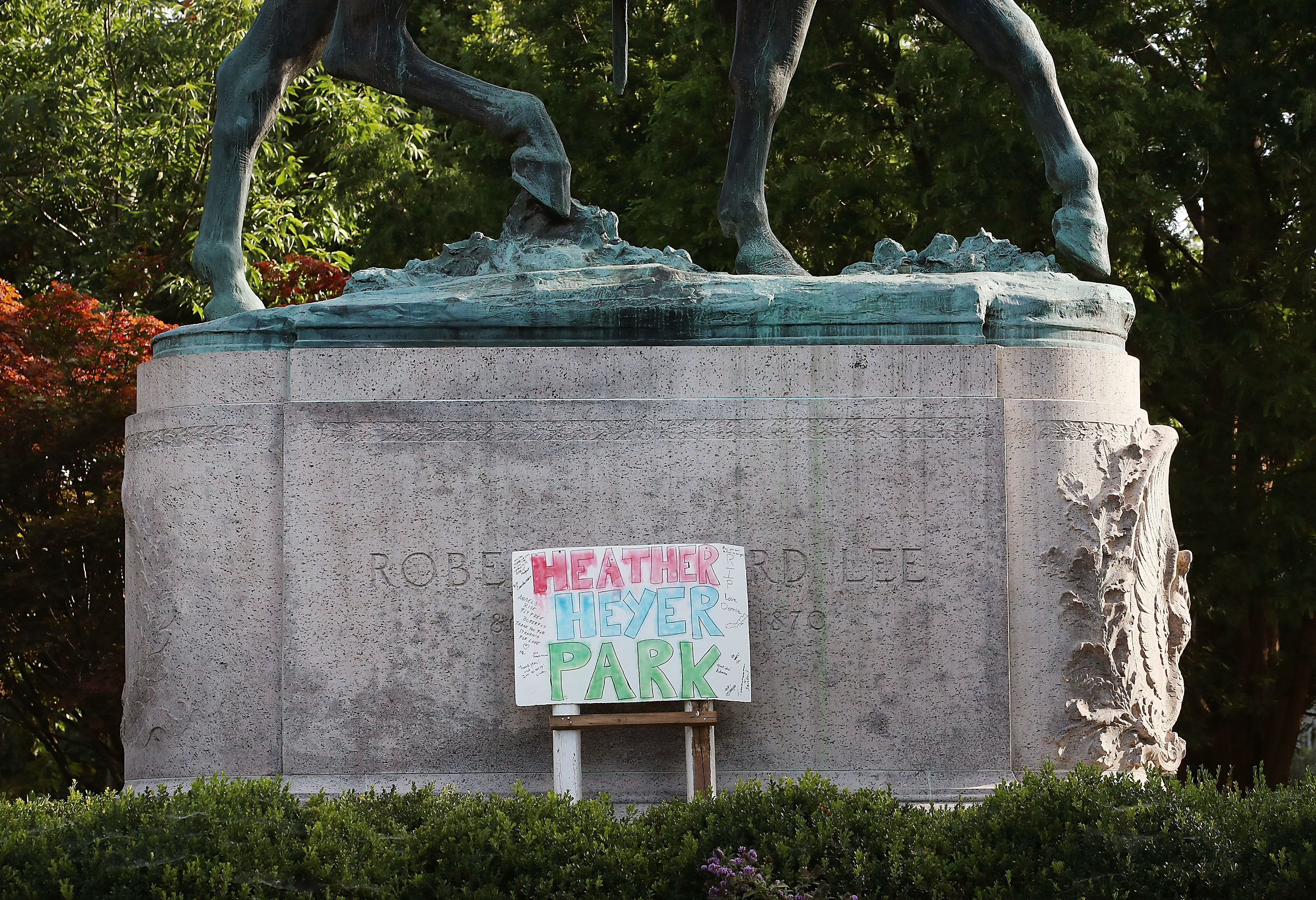 A homemade sign that says "Heather Heyer Park" rests at the base of the statue of Confederate Gen. Robert E. Lee that stands in the center of Emancipation Park on Aug. 18, 2017, in Charlottesville, Virginia. (Credit: Mark Wilson / Getty Images)