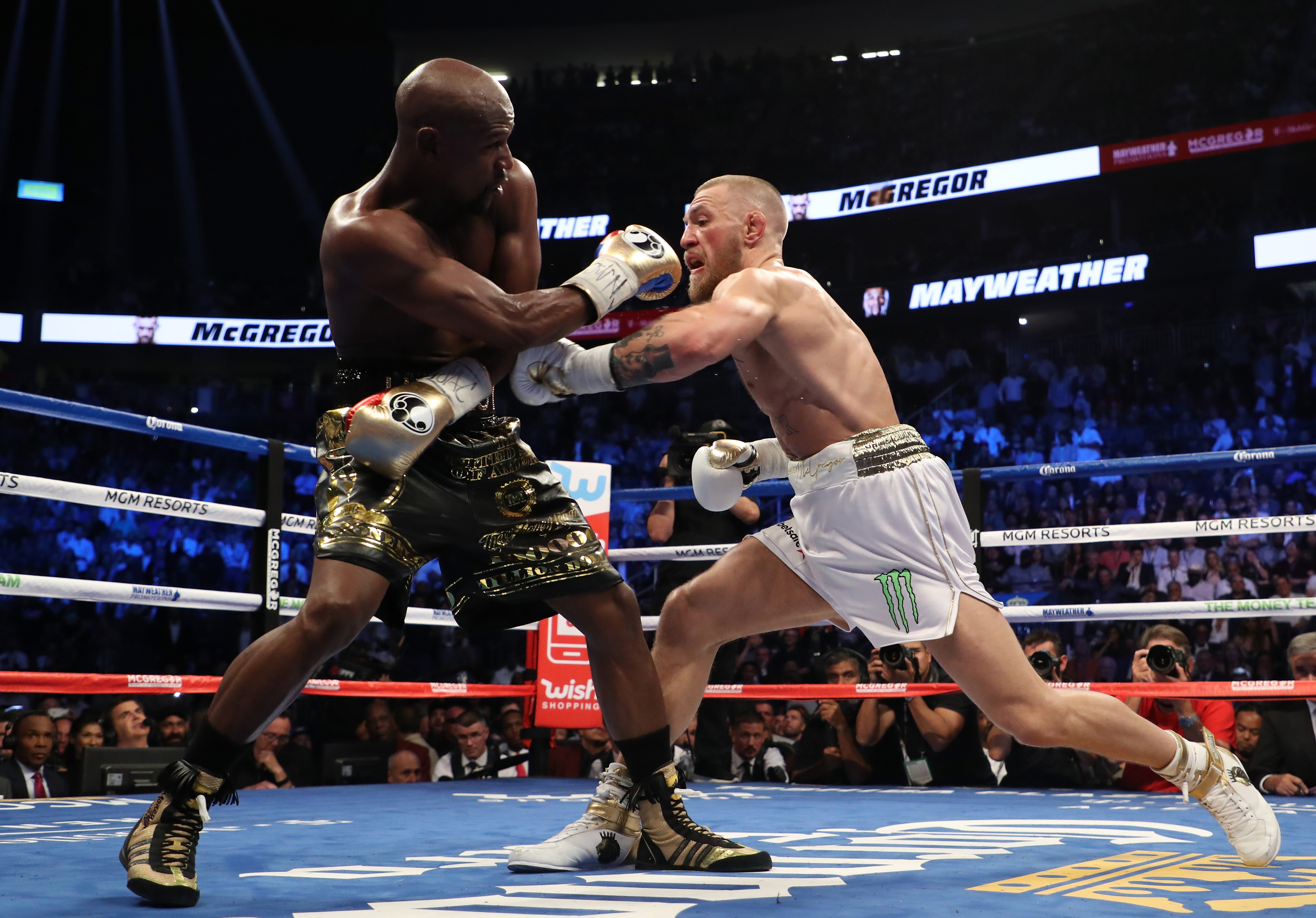 Conor McGregor throws a punch at Floyd Mayweather Jr. during their super welterweight boxing match on Aug. 26, 2017, at T-Mobile Arena in Las Vegas, Nevada. (Credit: Christian Petersen / Getty Images)