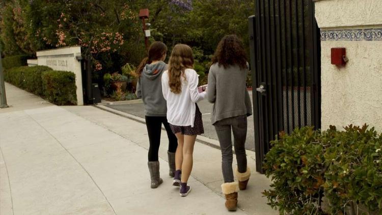 Students walk through the gated entrance of the elite Brentwood School in 2011. (Anne Cusack/Los Angeles Times)