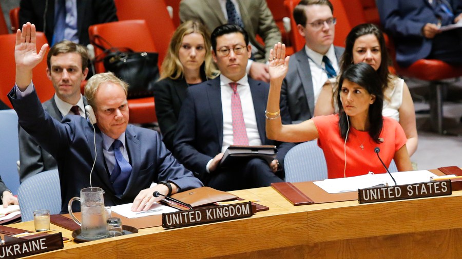 U.S. Ambassador to the United Nations Nikki Haley and Britain's Ambassador Matthew Rycroft vote on a U.S.-drafted resolution toughening sanctions on North Korea, at the United Nations Headquarters in New York City on August 5, 2017. (Credit: Eduardo Munoz Alvarez/AFP/Getty Images)