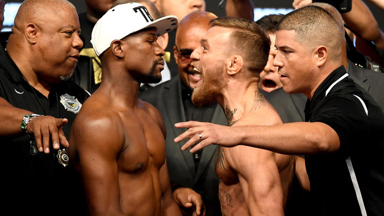 Floyd Mayweather Jr. and Conor McGregor face off after they weighed in on Aug. 25, 2017. (Credit: Ethan Miller / Getty Images)