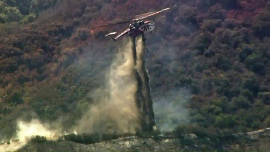 A helicopter helps battle the Canyon Fire near Corona. (Credit: KTLA)