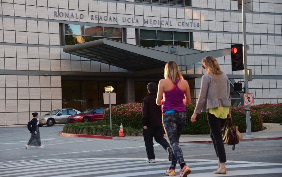 Pedestrians cross the road to the Ronald Reagan UCLA Medical Center on March 5, 2015. (Credit: Frederic J. Brown / AFP / Getty Images)