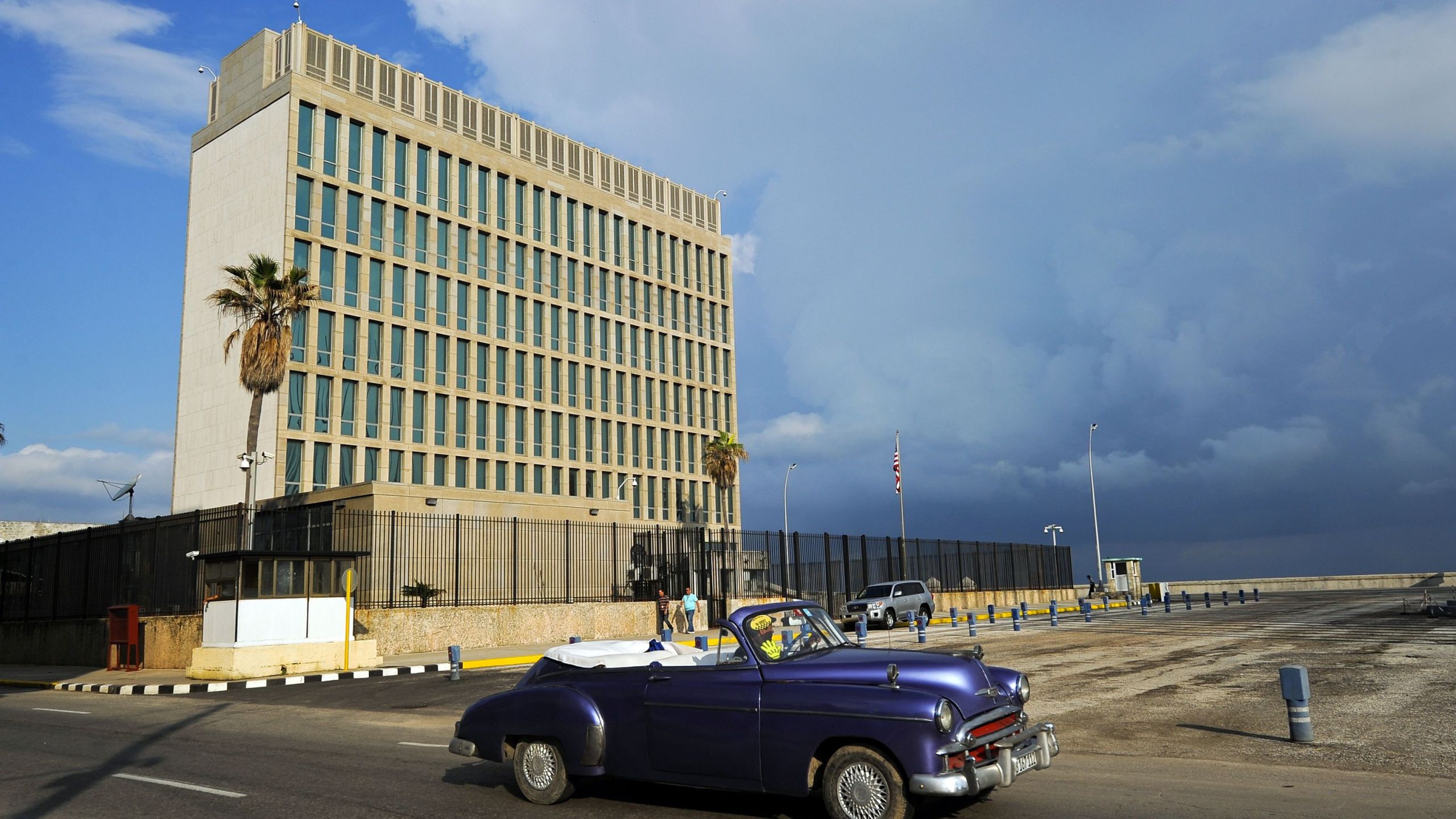 An old American car passes by the U.S. Embassy in Havana on Dec. 17, 2015. (Credit: Yamil Lage / AFP / Getty Images)