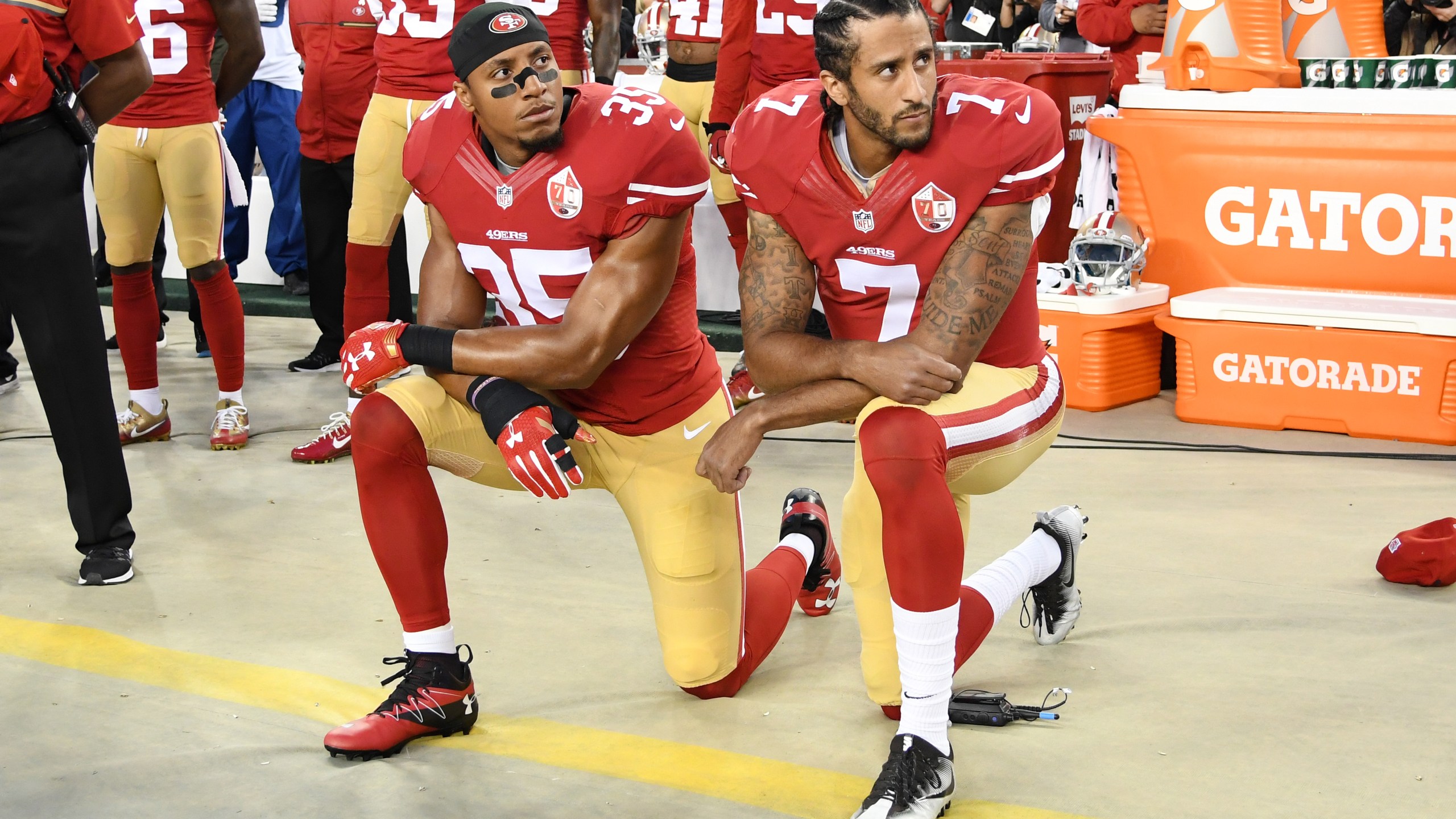 Colin Kaepernick and Eric Reid of the San Francisco 49ers kneel in protest during the national anthem prior to playing the Los Angeles Rams in their NFL game at Levi's Stadium on Sept. 12, 2016. (Credit: Thearon W. Henderson / Getty Images)