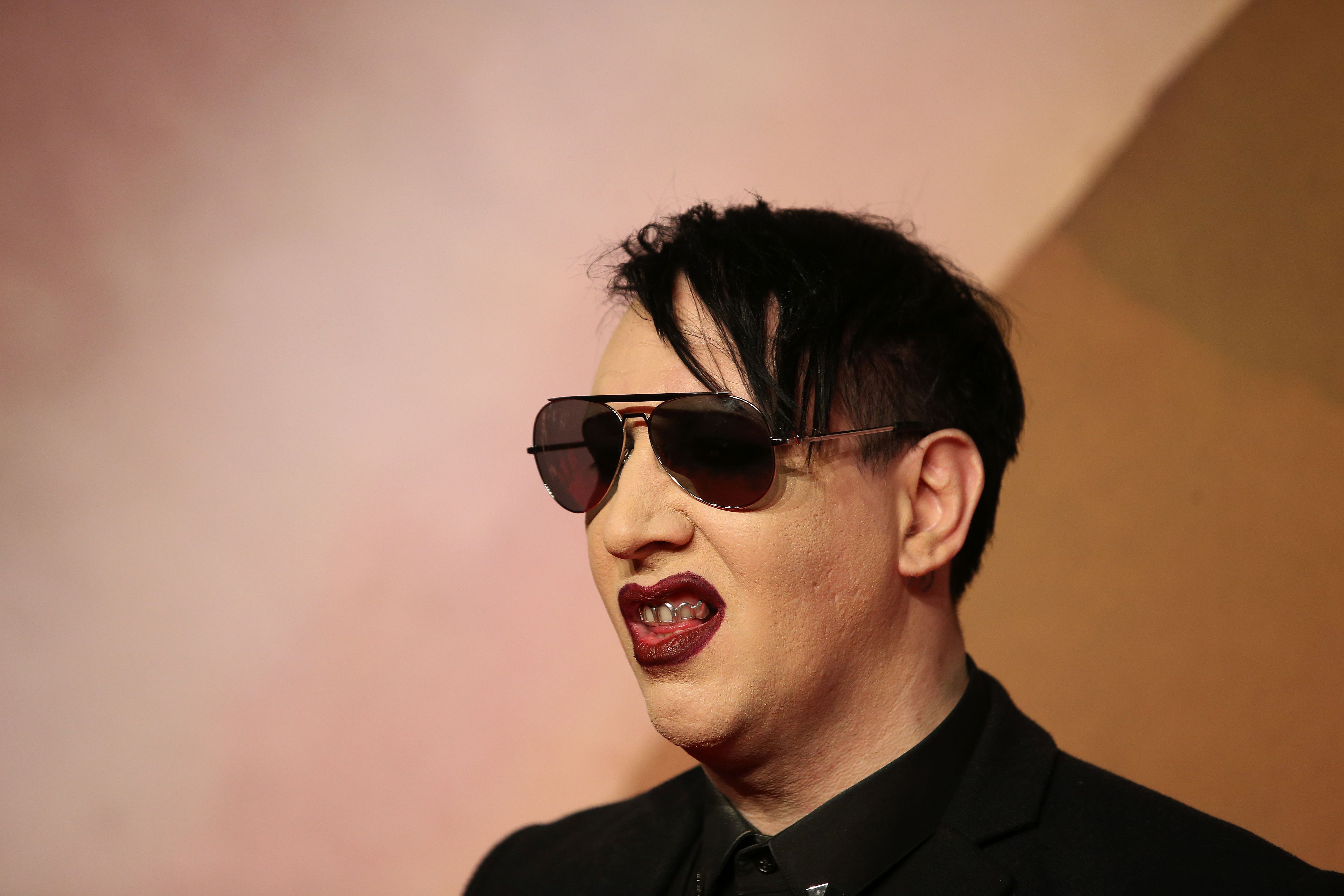 Singer Marilyn Manson poses for pictures on the red carpet upon arrival to attend the British Fashion Awards 2016 in London on Dec. 5, 2016. (Credit: DANIEL LEAL-OLIVAS/AFP/Getty Images)