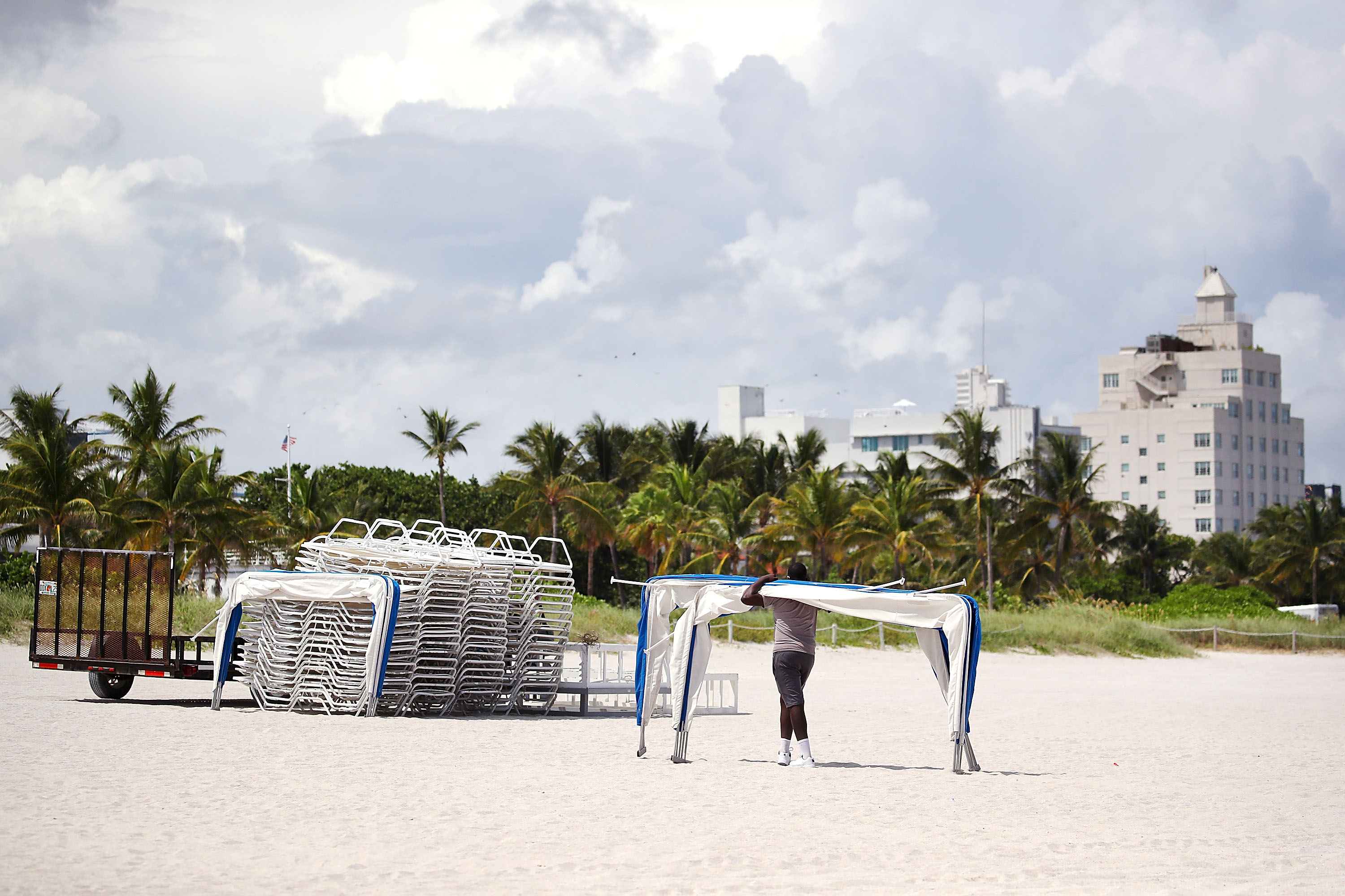 A worker removes beach awnings in Miami, preparing for Hurricane Irma, on Sept. 6, 2016. (Credit: Mark Wilson/Getty Images)