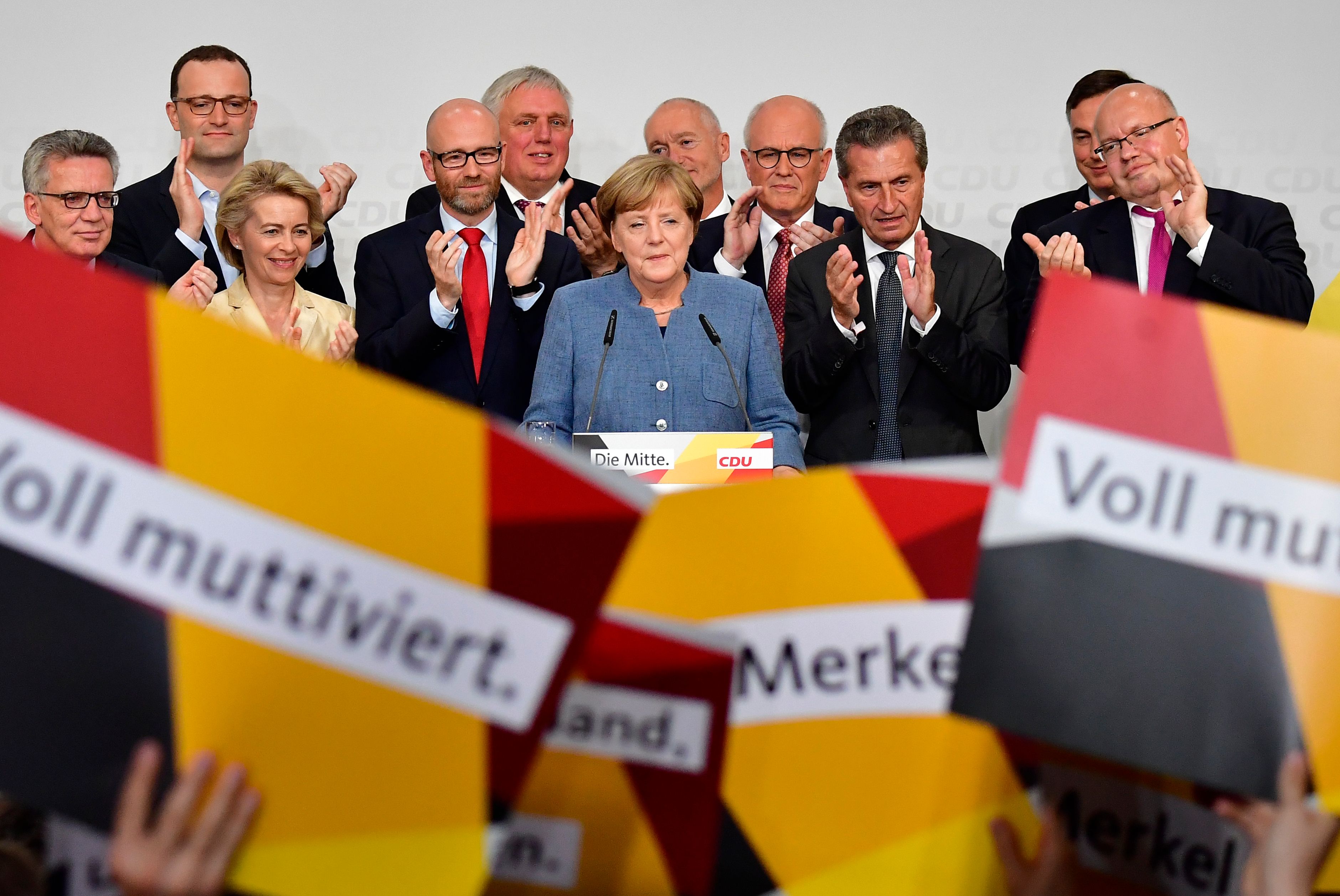 German Chancellor and Christian Democrats party leader Angela Merkel speaks on stage surrounded by her team during an election night event at the party headquarters in Berlin on Sept. 24, 2017. (Credit: TOBIAS SCHWARZ / AFP / Getty Images)