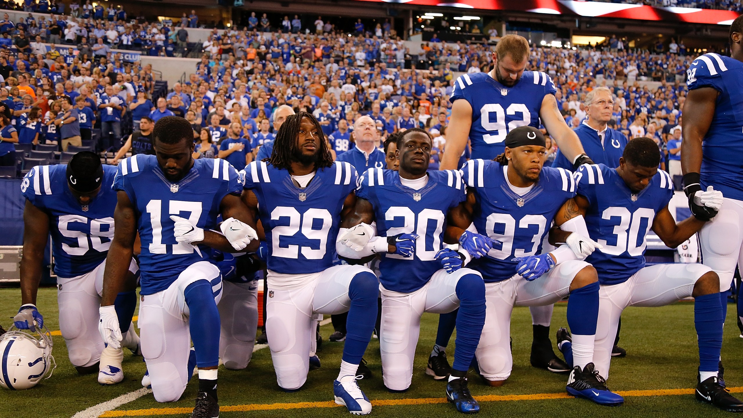 Members of the Indianapolis Colts stand and kneel for the national anthem prior to the start of the game between the Indianapolis Colts and the Cleveland Browns at Lucas Oil Stadium on Sept. 24, 2017. (Credit: Michael Reaves / Getty Images)