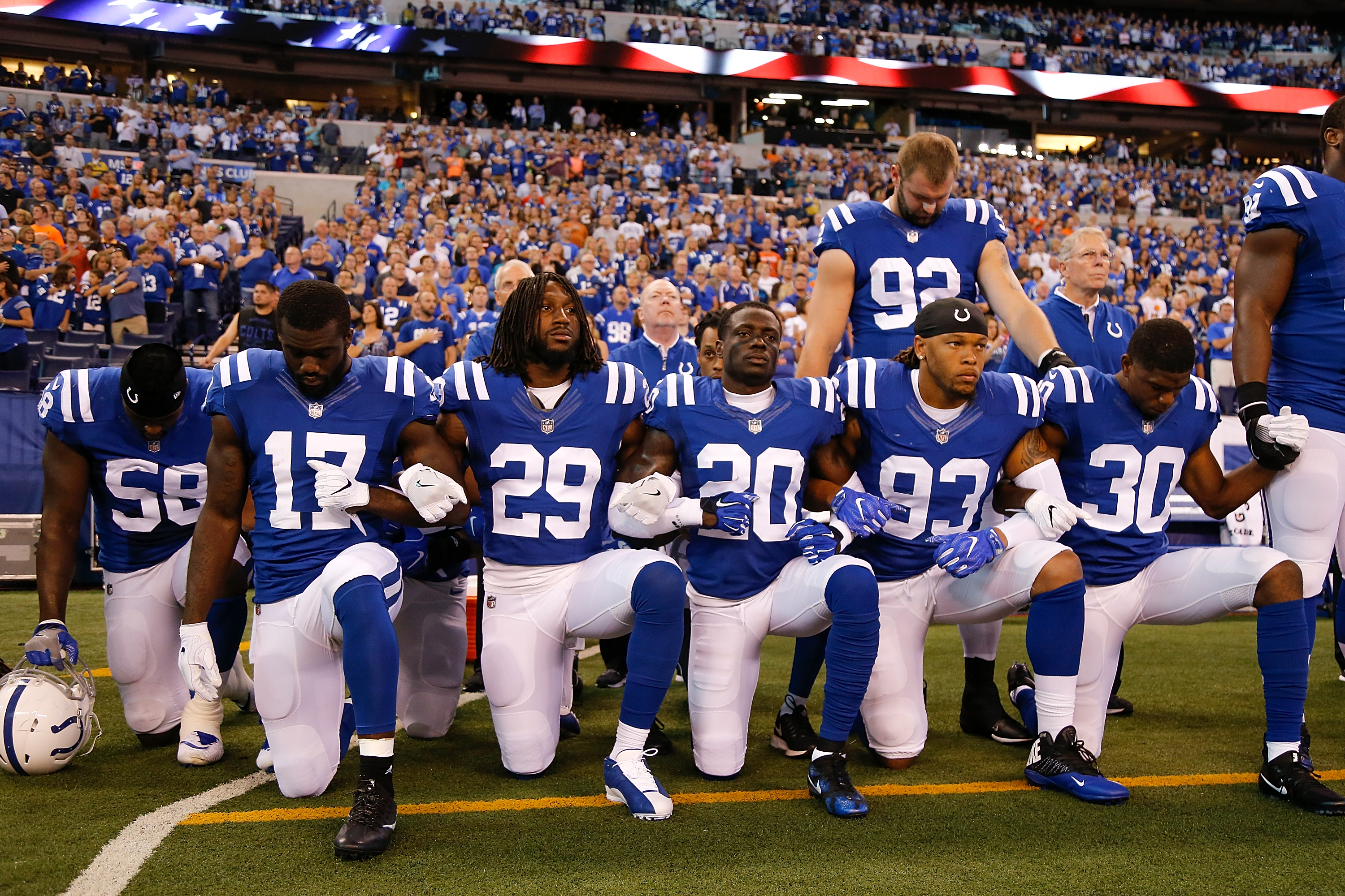 Members of the Indianapolis Colts stand and kneel for the national anthem prior to the start of the game between the Indianapolis Colts and the Cleveland Browns at Lucas Oil Stadium on Sept. 24, 2017. (Credit: Michael Reaves / Getty Images)