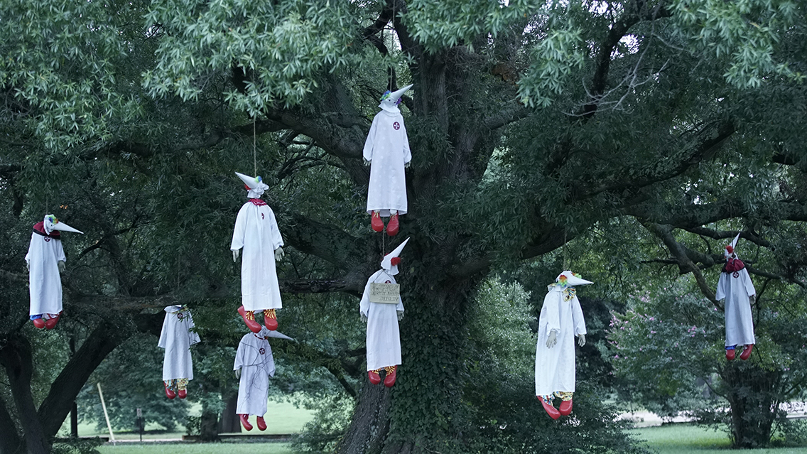 Eight figures dressed as clowns in Ku Klux Klan robes were hung from a tree in a Richmond, Virginia, park on Sept. 7, 2017. (Credit: Indecline)