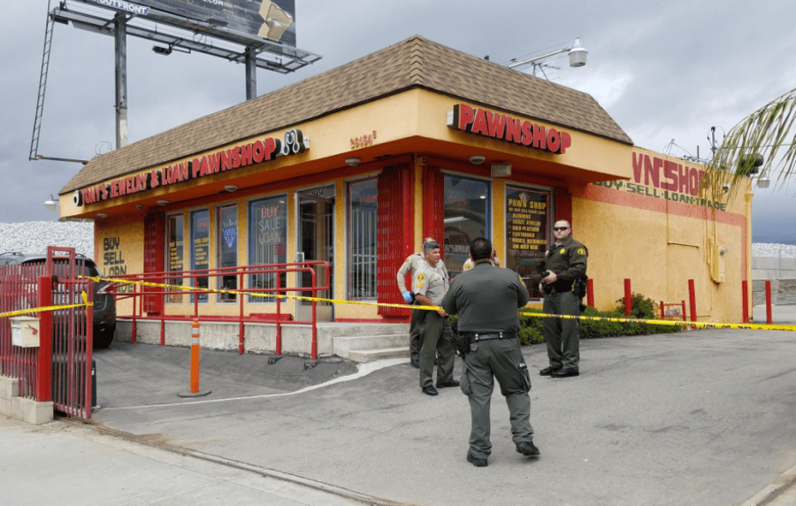 Police respond to a shooting at a pawn shop in Highland that left two people injured on Sept. 21, 2017. (Credit: San Bernardino Sun)