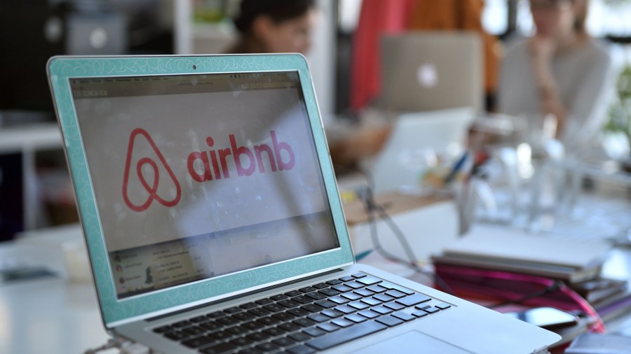 A screen showing the logo for lodging service Airbnb is seen on a computer screen in the company's offices in Paris on April 21, 2015.(Credit: Martin Bureau/AFP/Getty Images)