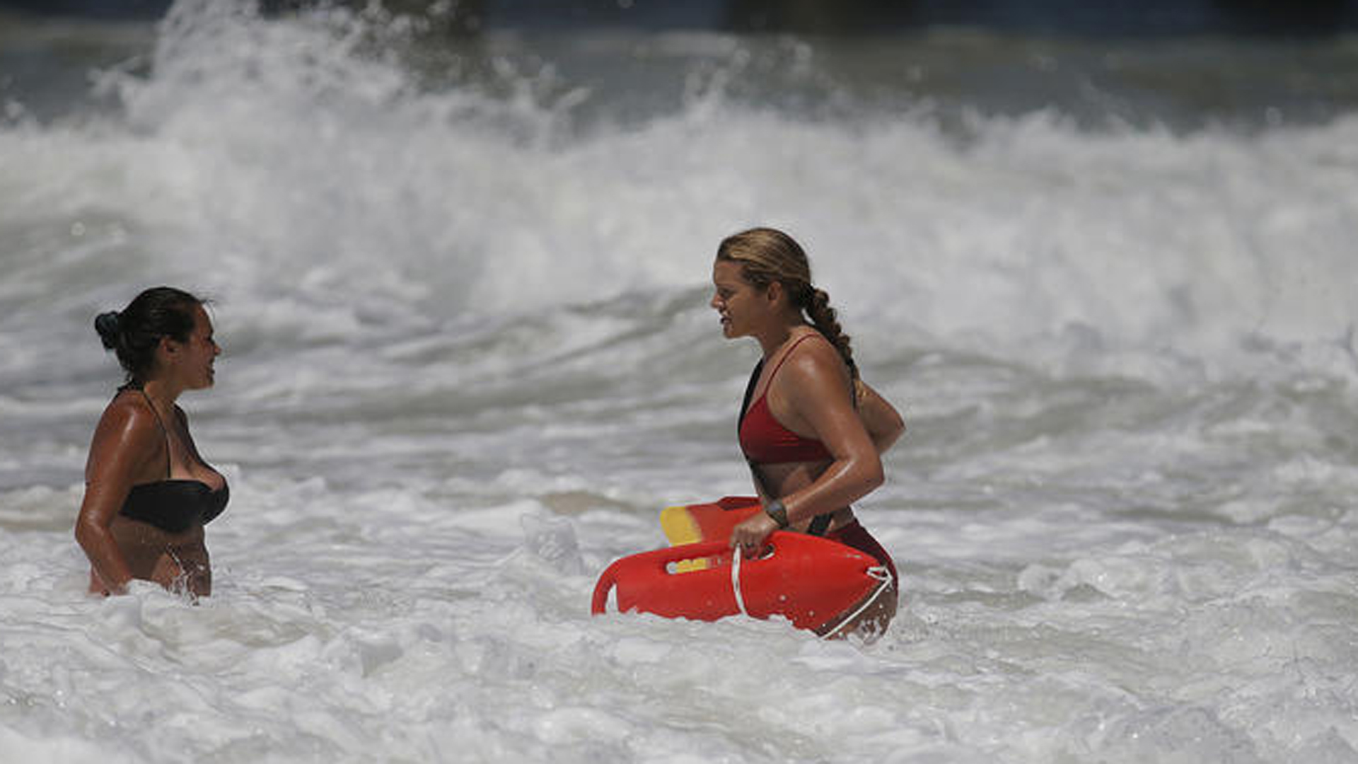 A 53-year-old man was reported missing about 4 p.m. off Huntington Beach. Above, a lifeguard warns a swimmer about rip currents in July. (Allen J. Schaben / Los Angeles Times)