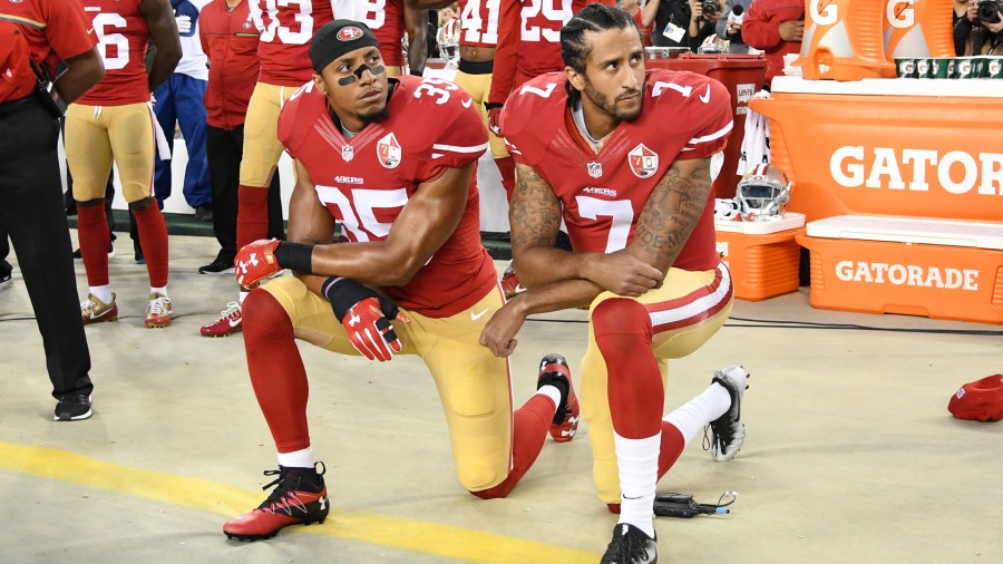 Colin Kaepernick and Eric Reid of the San Francisco 49ers kneel in protest during the national anthem prior to playing the Los Angeles Rams in their NFL game at Levi's Stadium on Sept. 12, 2016. (Credit: Thearon W. Henderson / Getty Images)