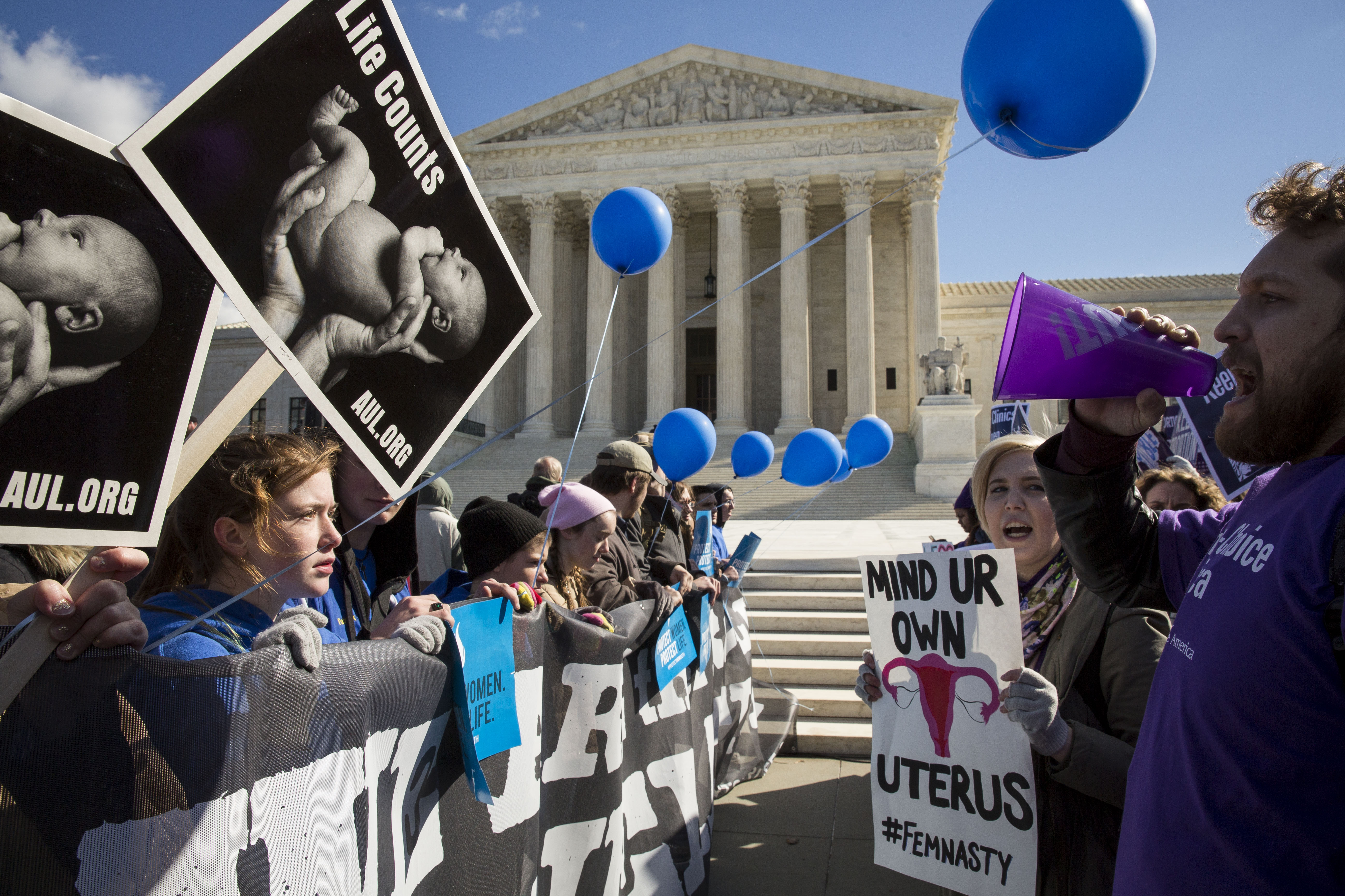 Pro-choice advocates (right) and anti-abortion advocates (left) rally outside of the Supreme Court, March 2, 2016 in Washington, DC. (Credit: Drew Angerer/Getty Images)