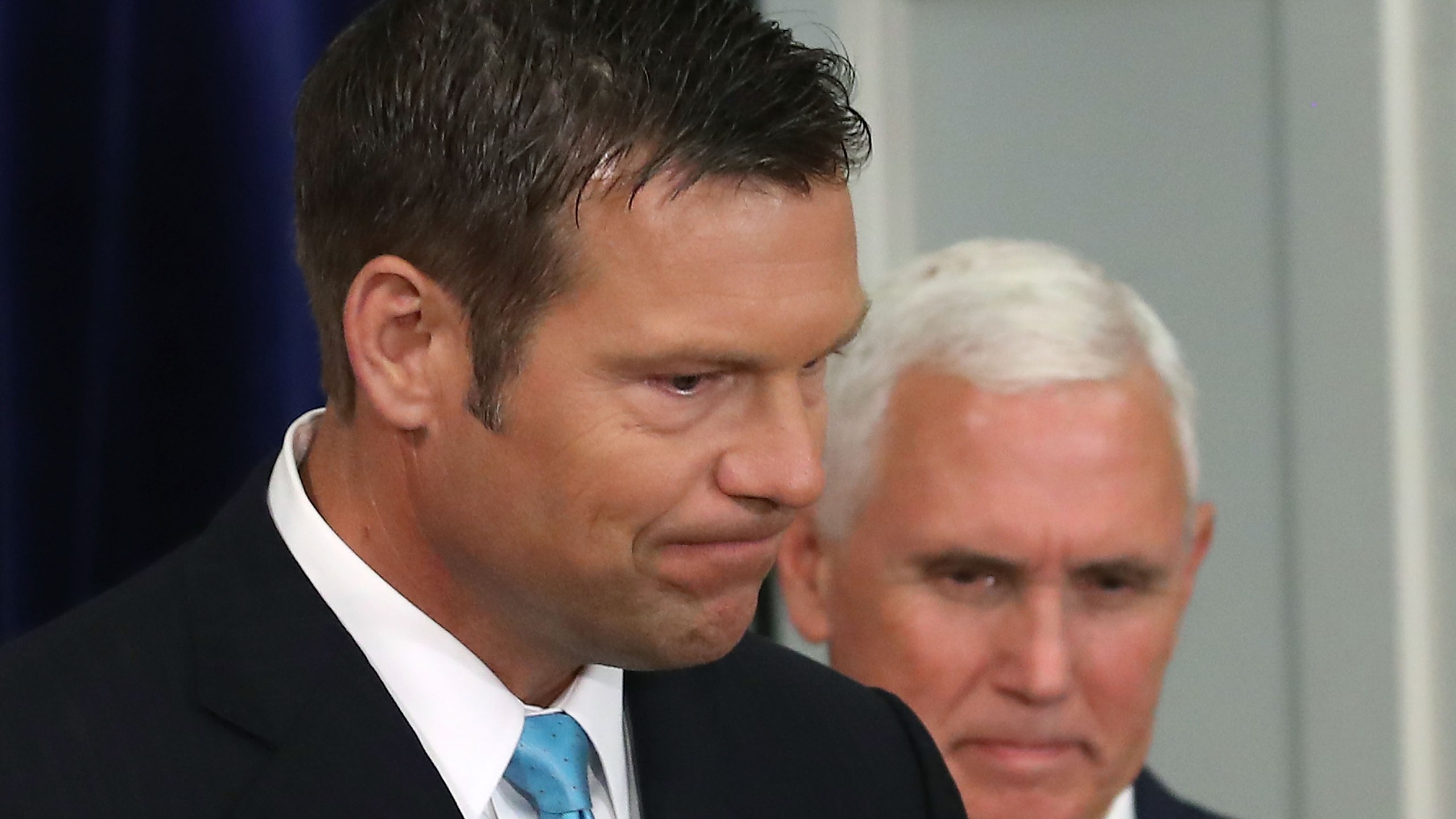 Kansas Secretary of State Kris Kobach, left, and Vice President Mike Pence attend the first meeting of the Presidential Advisory Commission on Election Integrity on July 19, 2017, in Washington, D.C. (Credit: Mark Wilson/Getty Images)