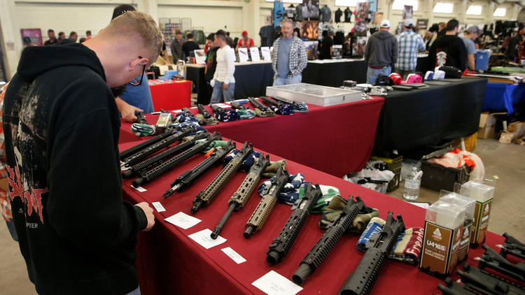 This file photo shows AR-15 semi-automatic assault rifle upper receiver parts and kits at the Crossroads of The West Gun Show in Del Mar on Dec. 12, 2015. (Los Angeles Times)