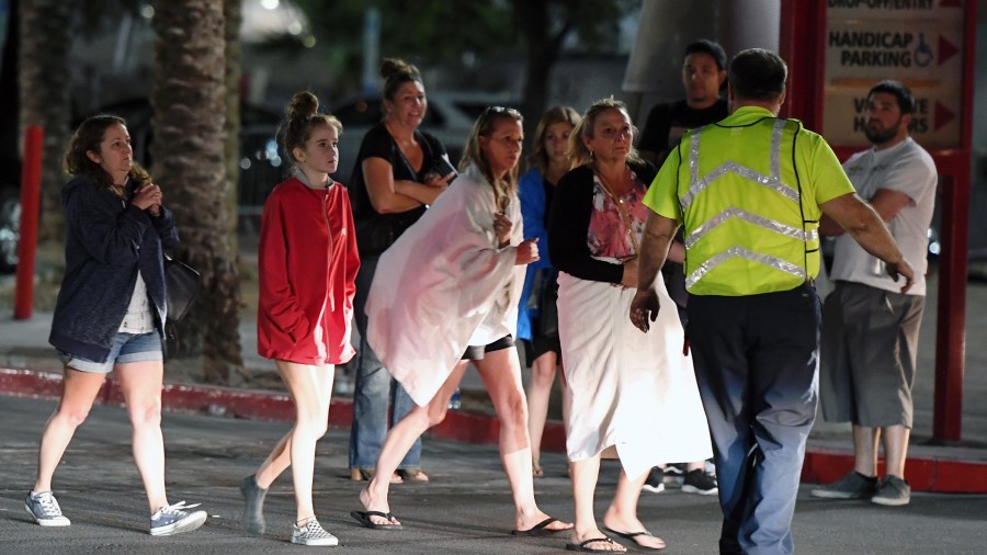 People are directed to rides outside the Thomas & Mack Center after a mass shooting at a country music festival on October 2, 2017 in Las Vegas. (Credit: Ethan Miller/Getty Images)