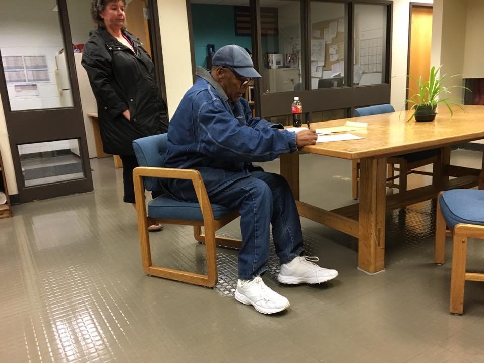 O.J. Simpson signs paperwork before his release from prison on Sunday, October 1, 2017. (Credit: CNN)