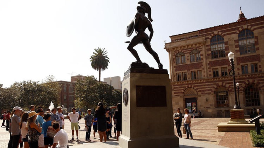 In this undated file photo, people gather around the Tommy Trojan statue at the center of USC's campus. (Al Seib / Los Angeles Times)