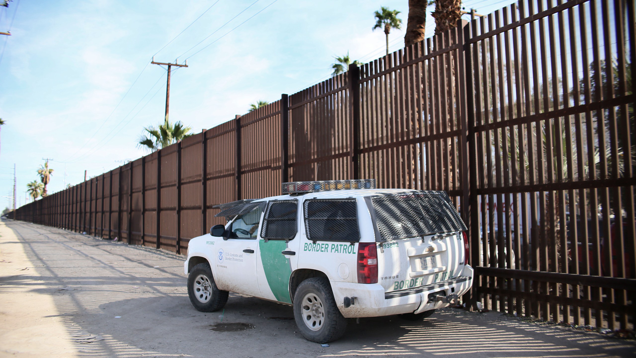 A Border Patrol agent looks over the U.S.-Mexico border wall in Calexico, California, in the Imperial Valley, on Jan. 31, 2017. (Credit: Sandy Huffaker / AFP / Getty Images)