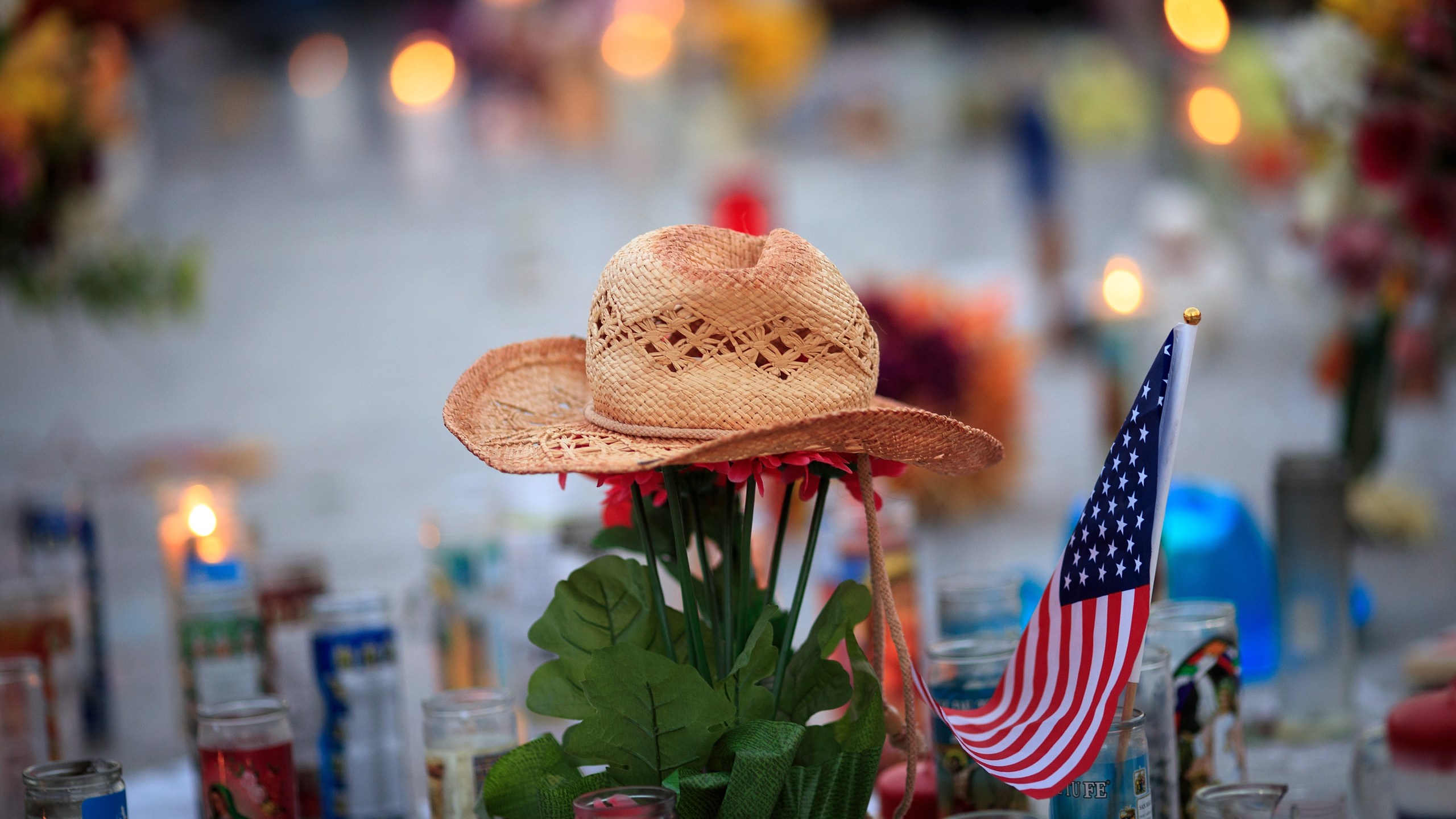 A hat is left at a makeshift memorial during a vigil to mark one week since the mass shooting at the Route 91 Harvest country music festival, on the corner of Sahara Avenue and Las Vegas Boulevard at the north end of the Las Vegas Strip, on Oct. 8, 2017. (Credit: Drew Angerer / Getty Images)