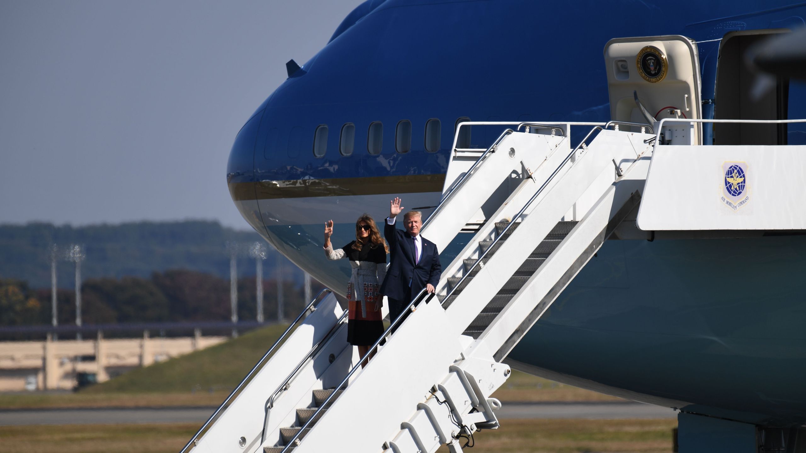 U.S. President Donald Trump and First Lady Melania Trump wave upon arriving at U.S. Yokota Air Base in Tokyo on Nov. 4, 2017. (Credit: Toshifumi Kitamura / AFP / Getty Images)