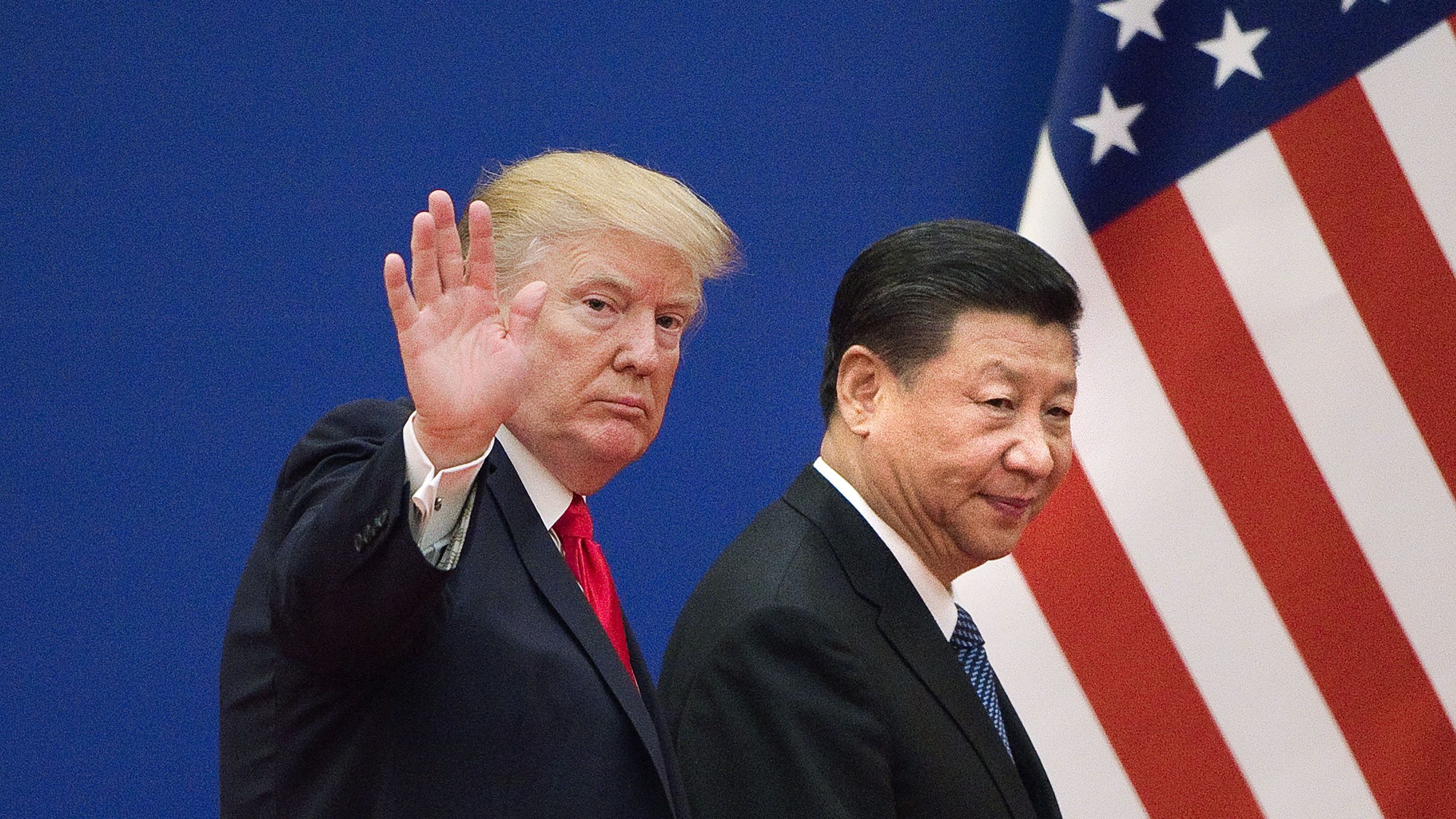 President Donald Trump and China's President Xi Jinping leave a business leaders event at the Great Hall of the People in Beijing on November 9, 2017. (Credit: NICOLAS ASFOURI/AFP/Getty Images)